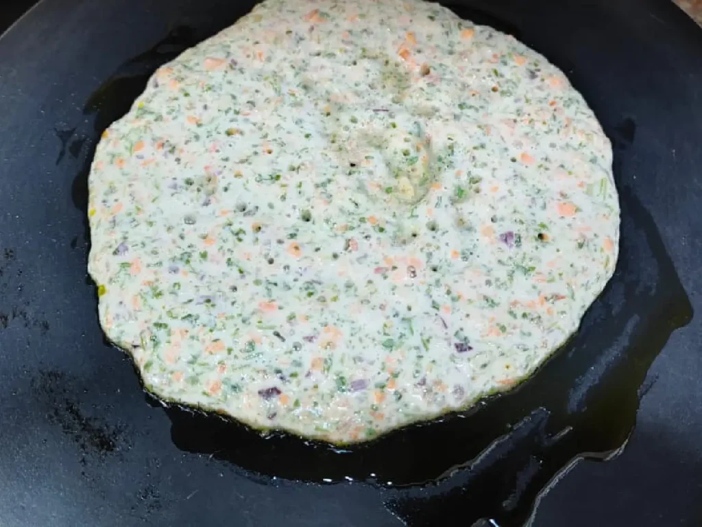 shape the batter on the tawa to cook